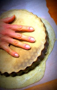 One hand on the dish, other hand underneath the greaseproof and flip over ...